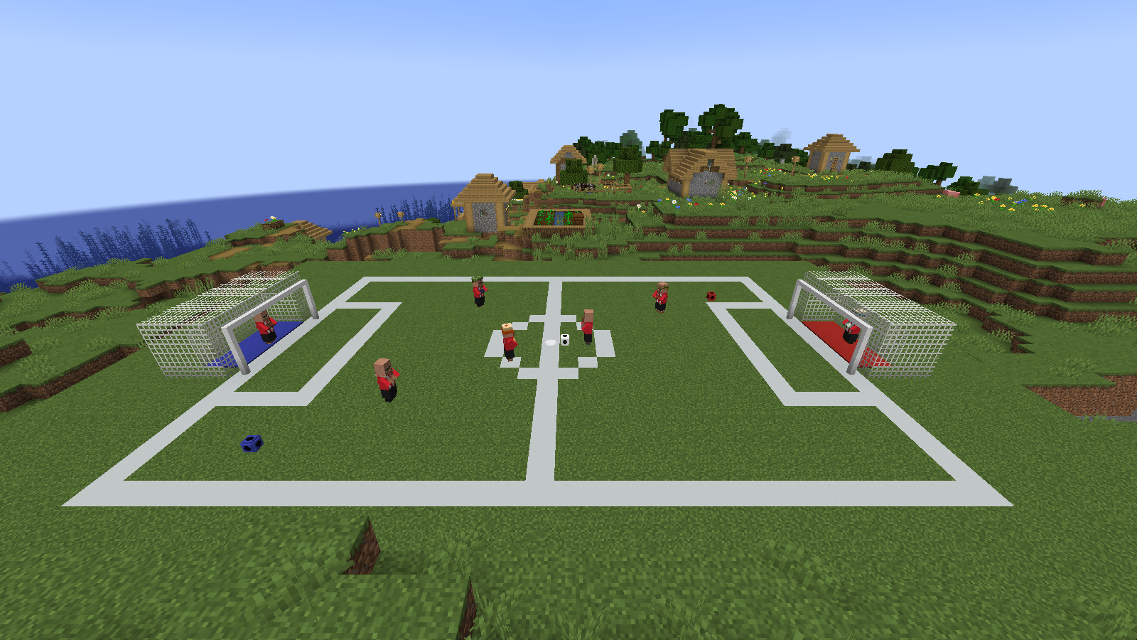 The ready-made pitch next to a plains village, with Footballer villagers on it