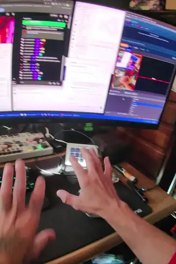 First-person video from the glasses in OBS: hands typing on a keyboard in front of a curved monitor