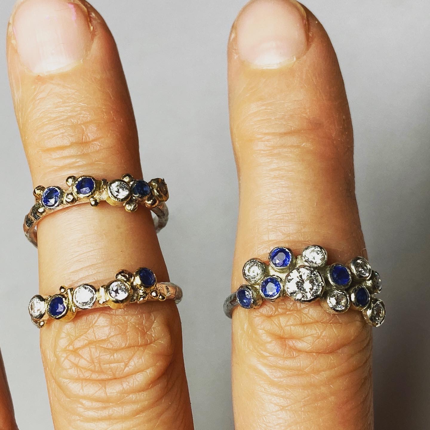 Handmade gemstone rings worn on fingers