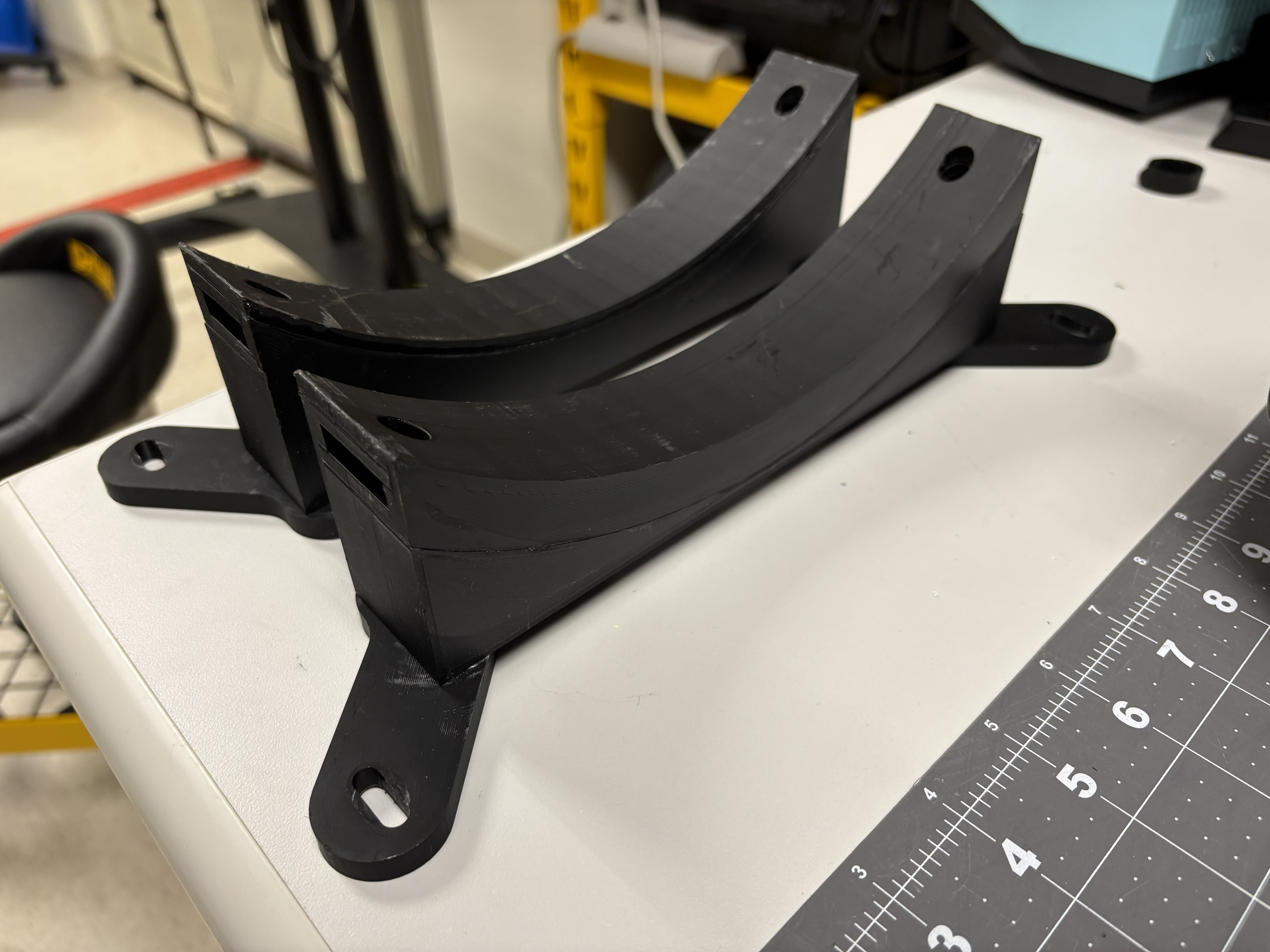 Curved foot assembly attached to the adjustment brackets.