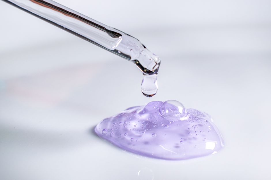 Pipette releasing a drop of purple gel onto a pool of the same gel — Photo by Fernando Serrano on Pexels