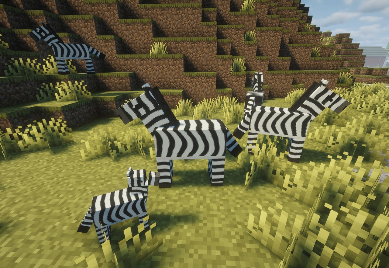 A zebra herd with a foal on a savanna hillside