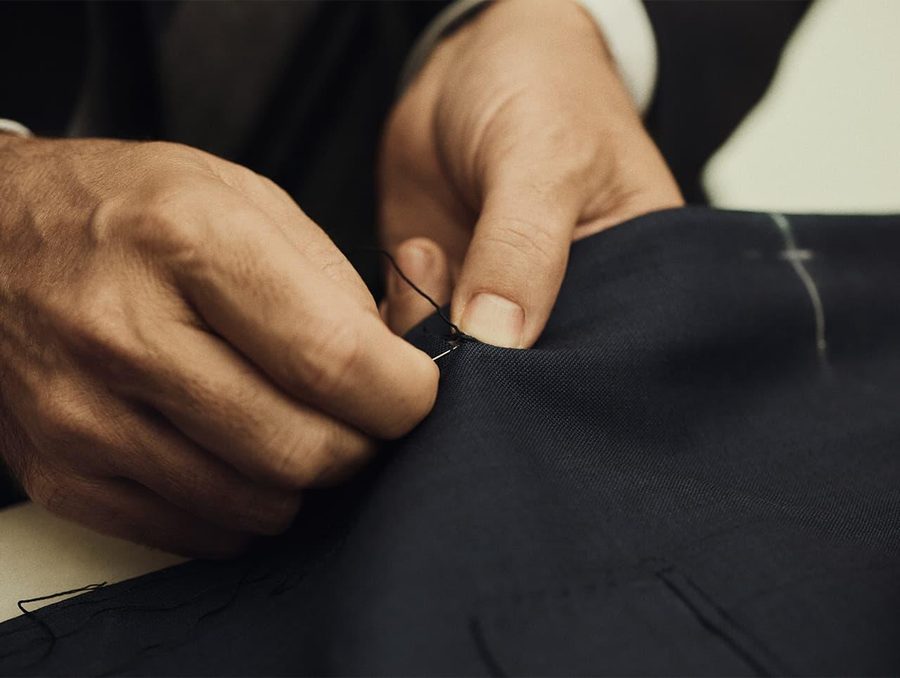Hand stitching detail work on dark technical fabric