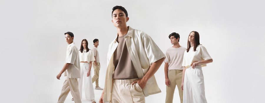 Minimal white cut and sew apparel collection on models