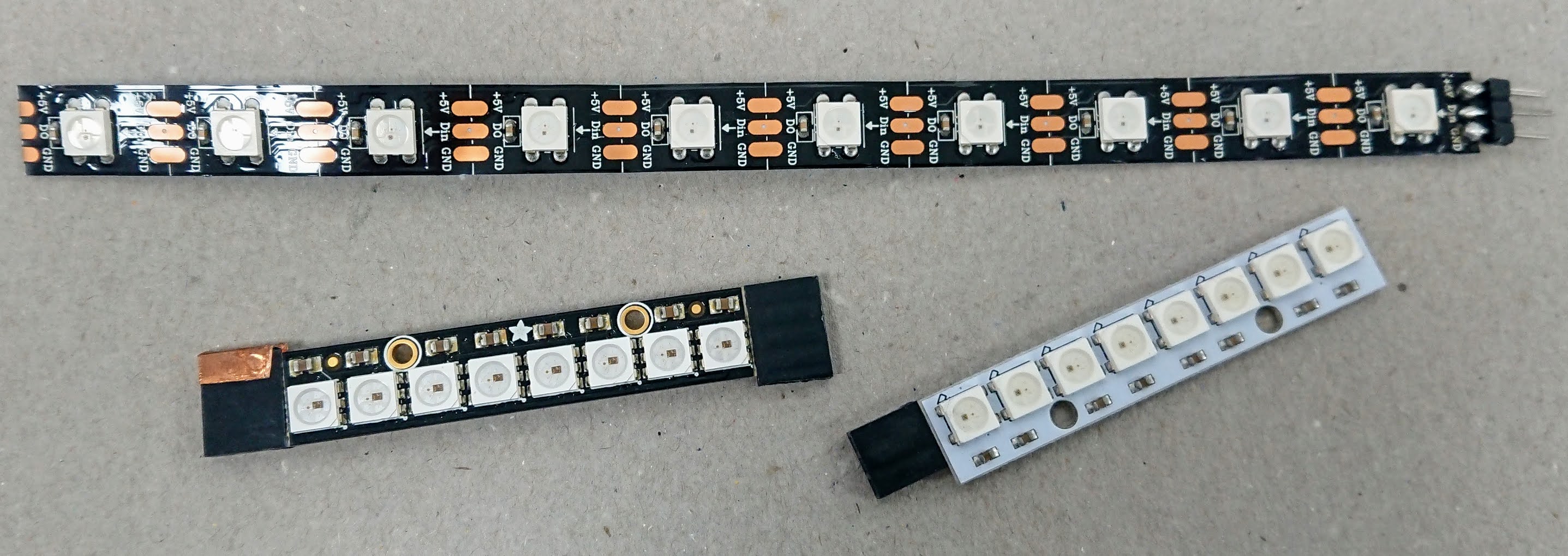10 square LEDs on a black strip; a strip of 8 square LEDs, closer together, on a black strip; a strip of 8 square LEDs, closer together, on a white strip