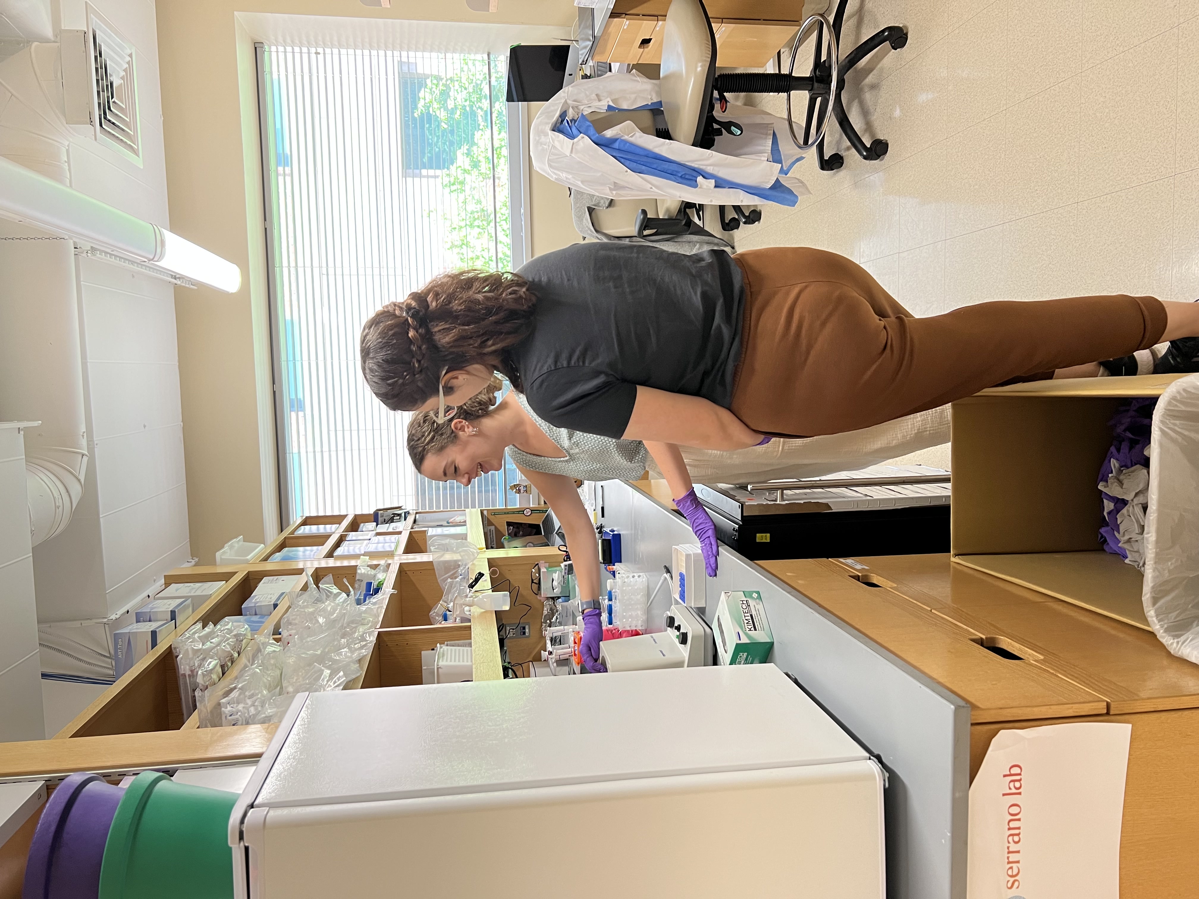 Saylor mentoring Emilia at the bench