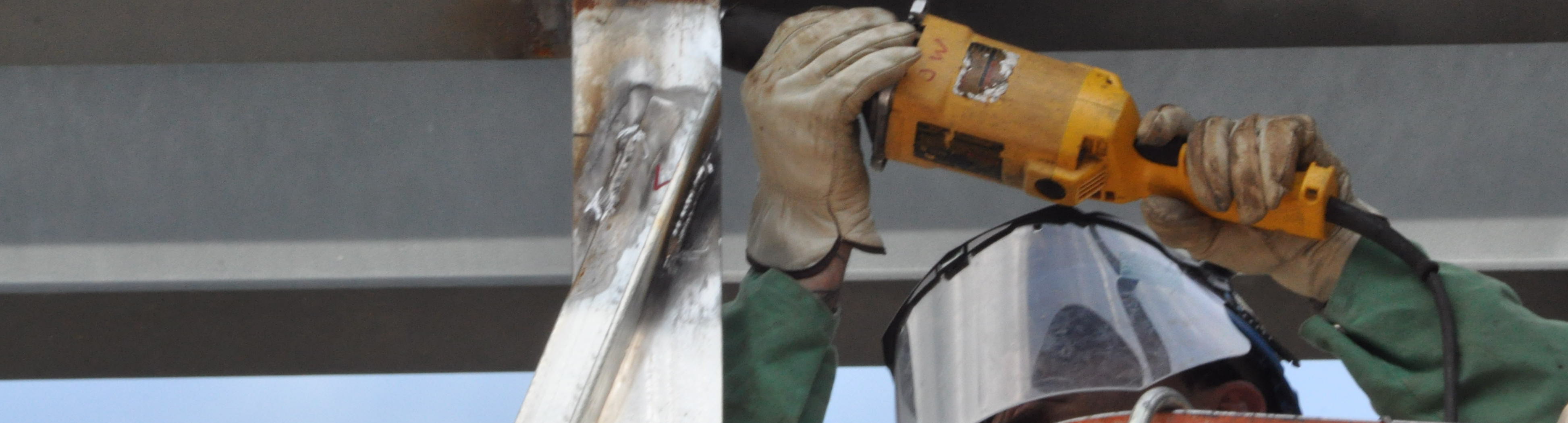 A worker welding a pipe