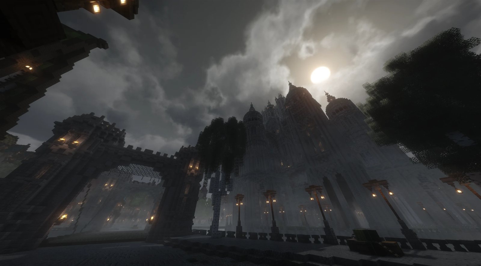 A cathedral and gatehouse at night