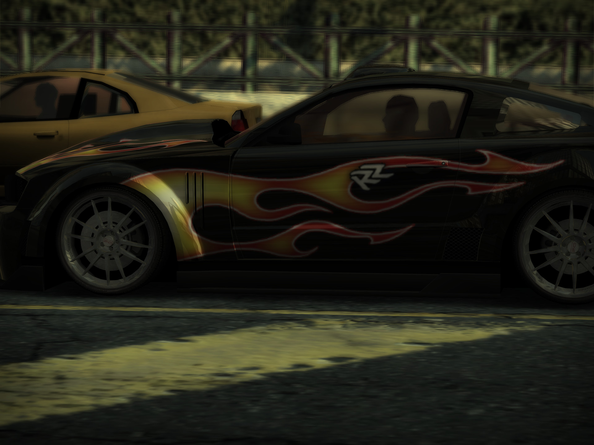 A close-up of a black car with flame livery, in a 4:3 frame