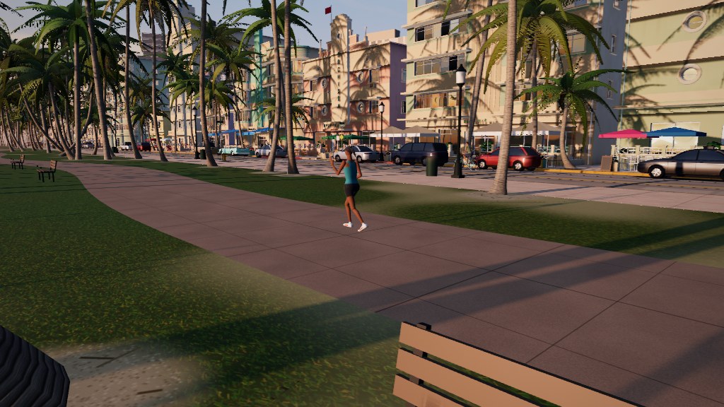 The park promenade, with a jogger and the café patios across the street