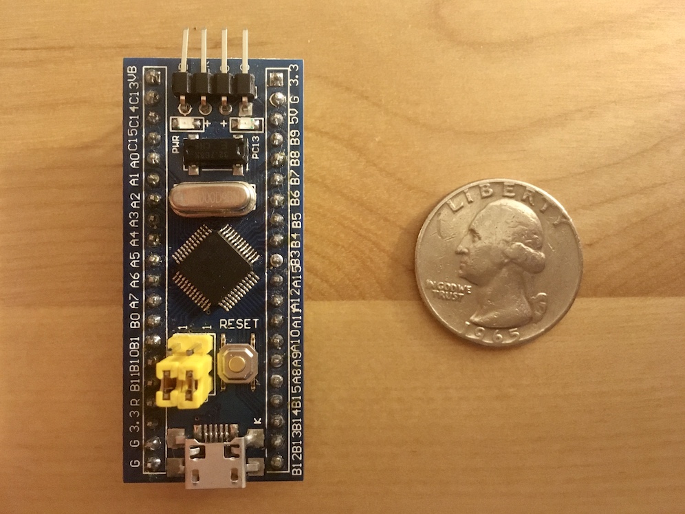 A small, rectangular, and blue printed circuit board assembly