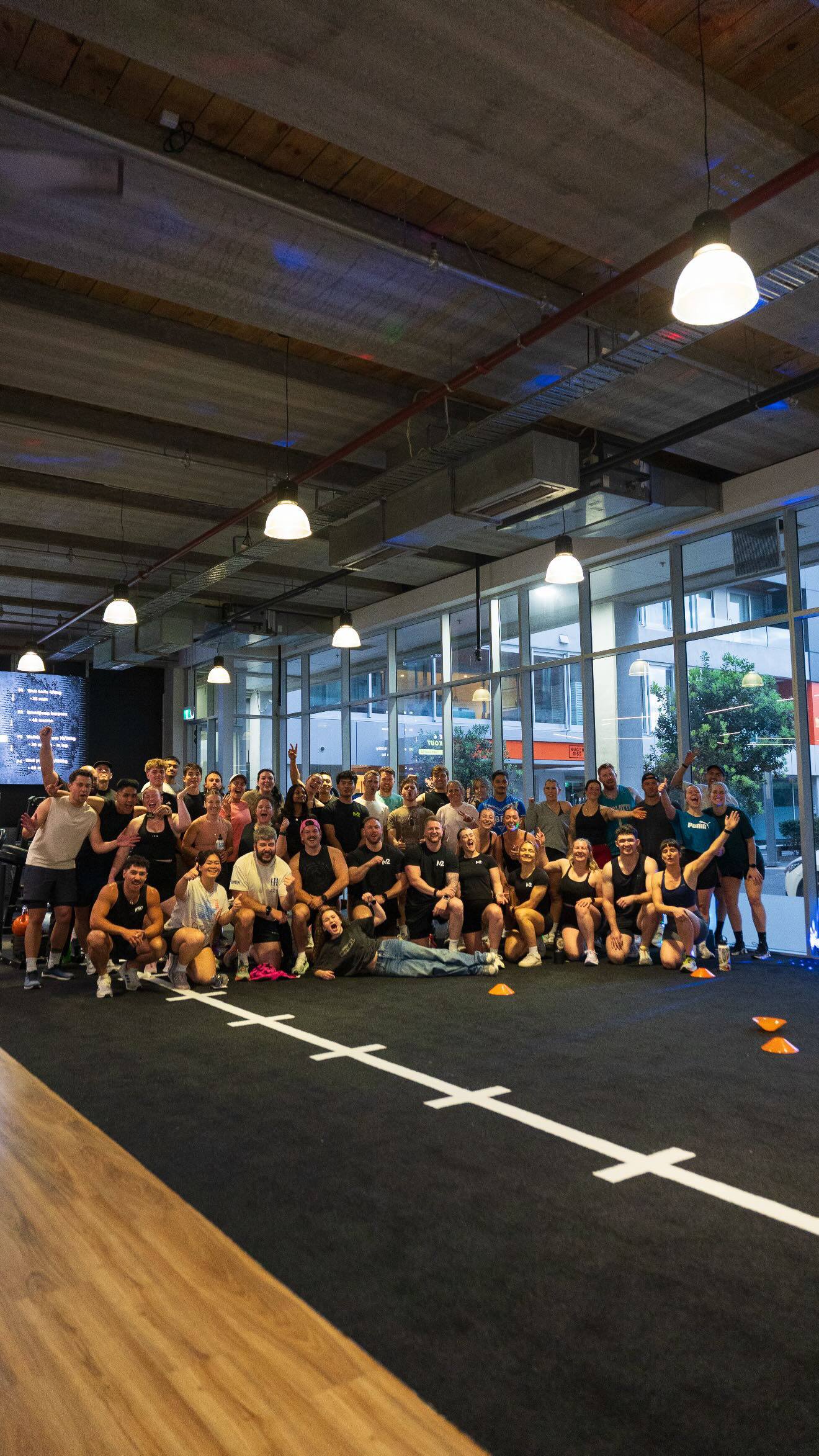 Large group of M2 members posing together after a group training session