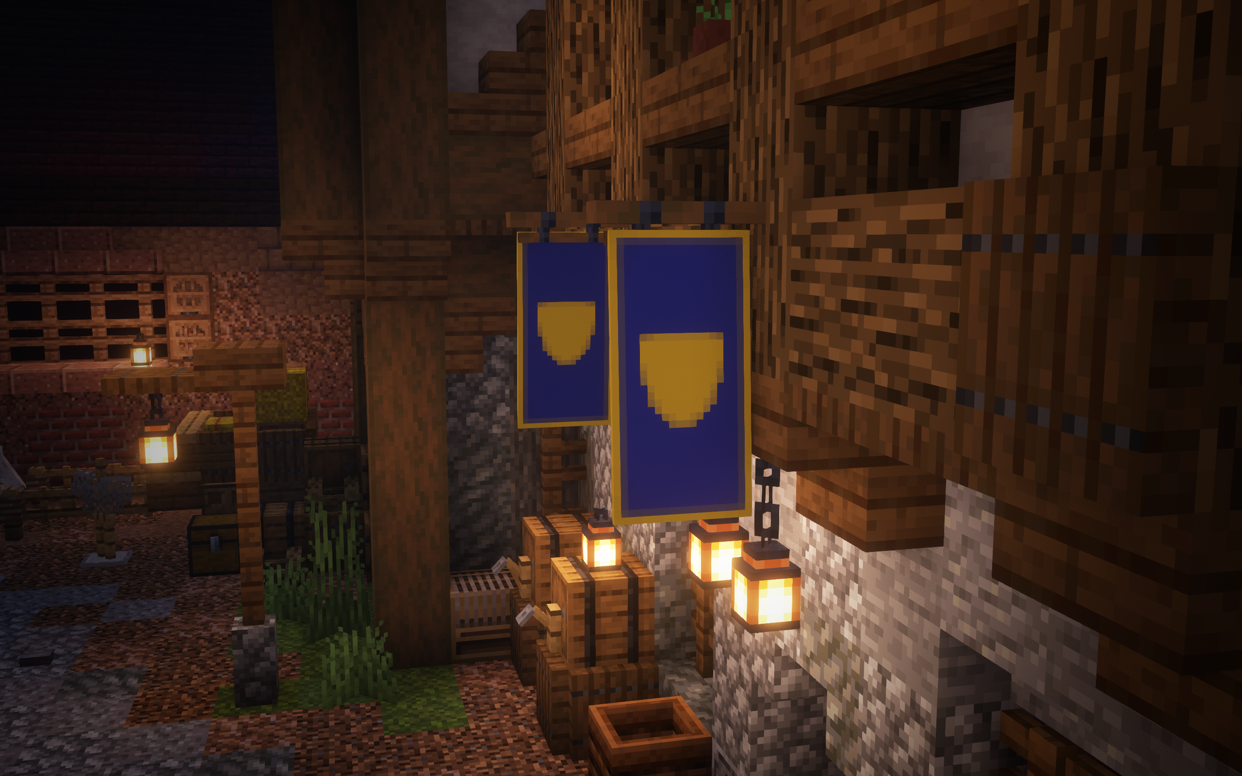 Two banners hanging above the entrance to a medieval tavern. They're both identical blue banners with a thin, yellow outline, and have a shield shape in the middle.