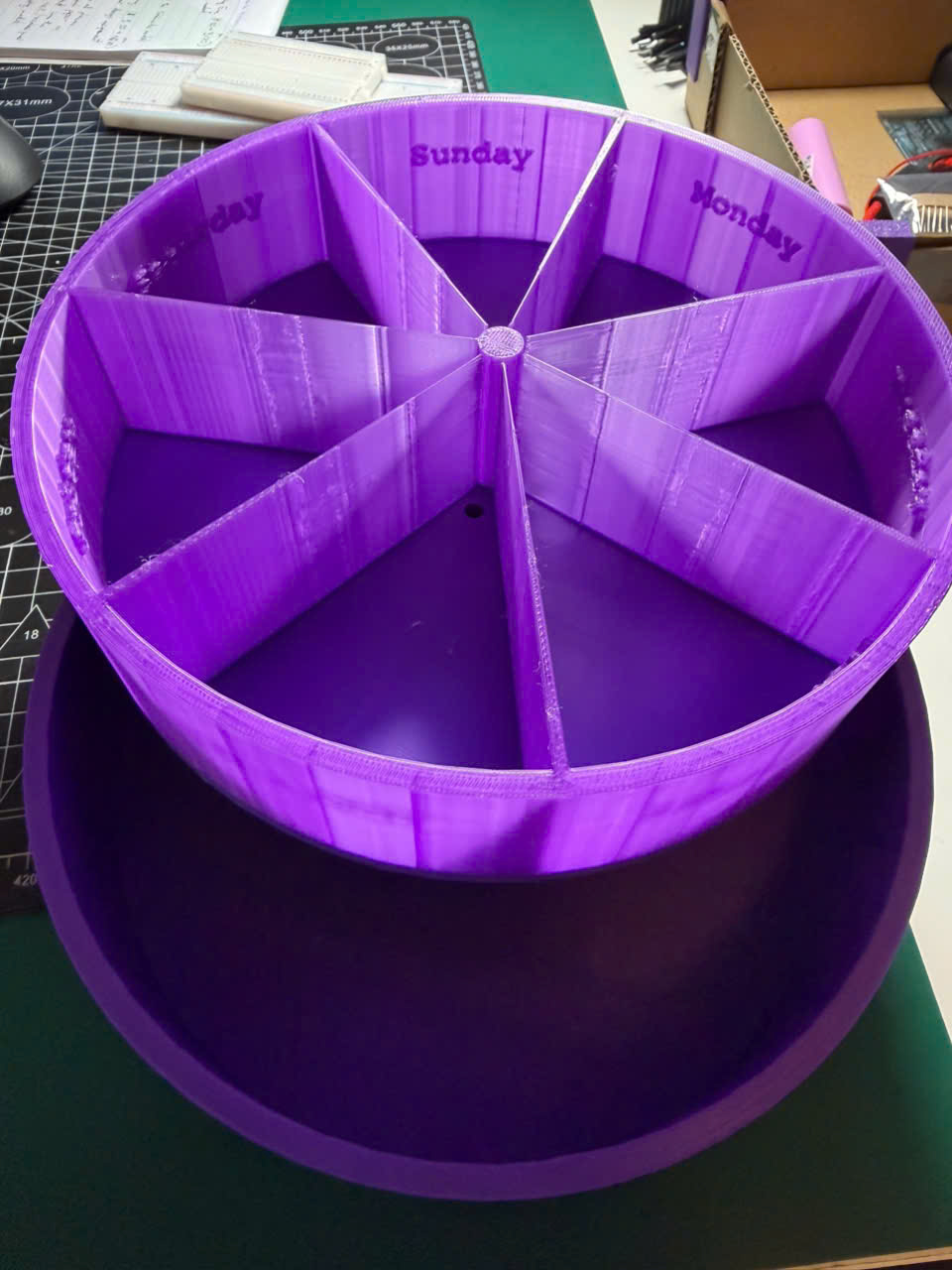 First purple 3D-printed pill organizer with labeled weekday compartments