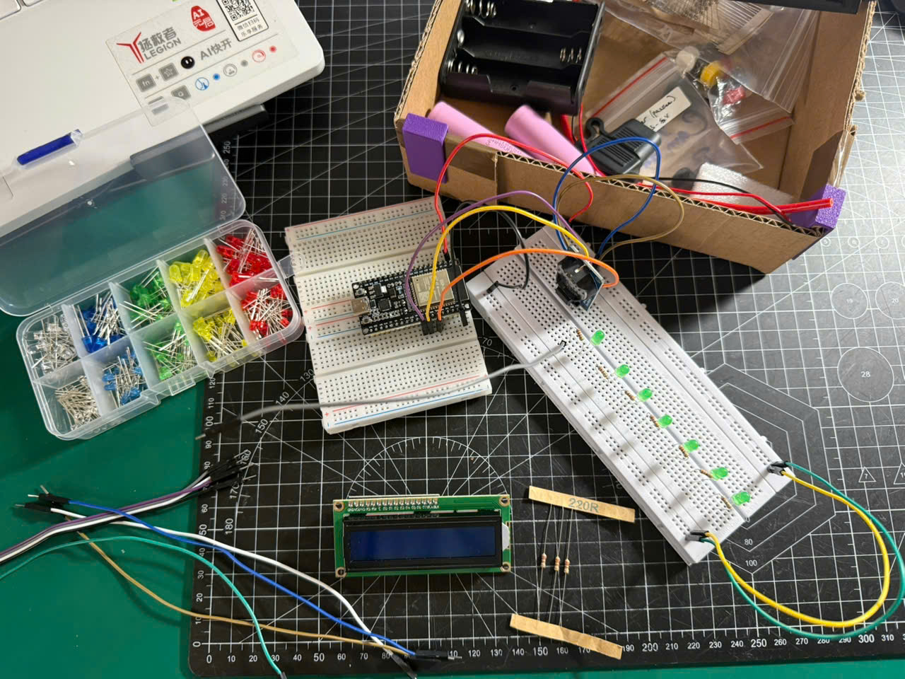 ESP32 breadboard prototype with the LCD and a row of seven LEDs