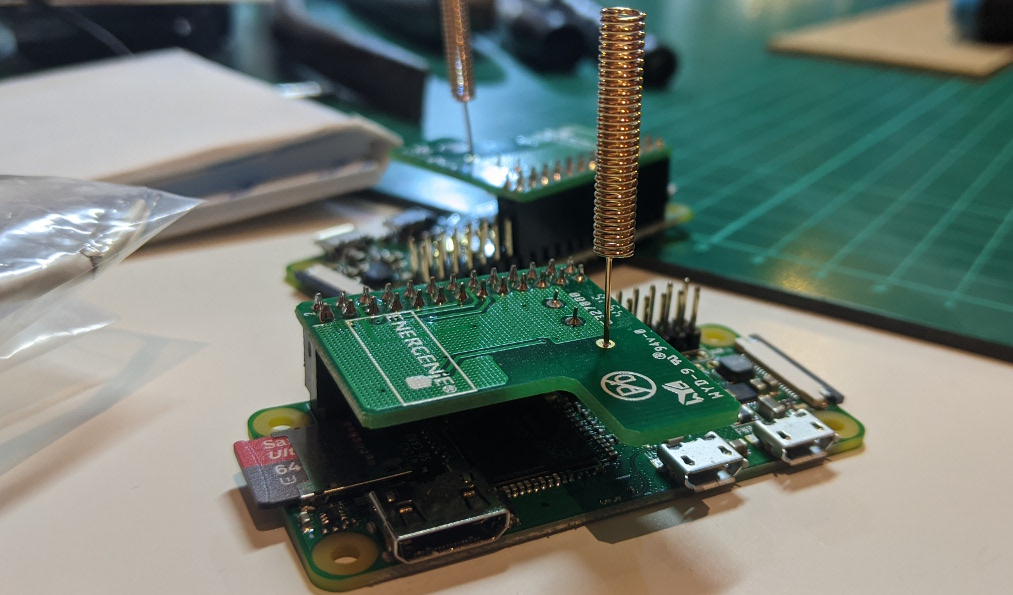 Photograph of a Raspberry Pi with an attached Energenie Pi-mote control board and a small copper antenna soldered to the board