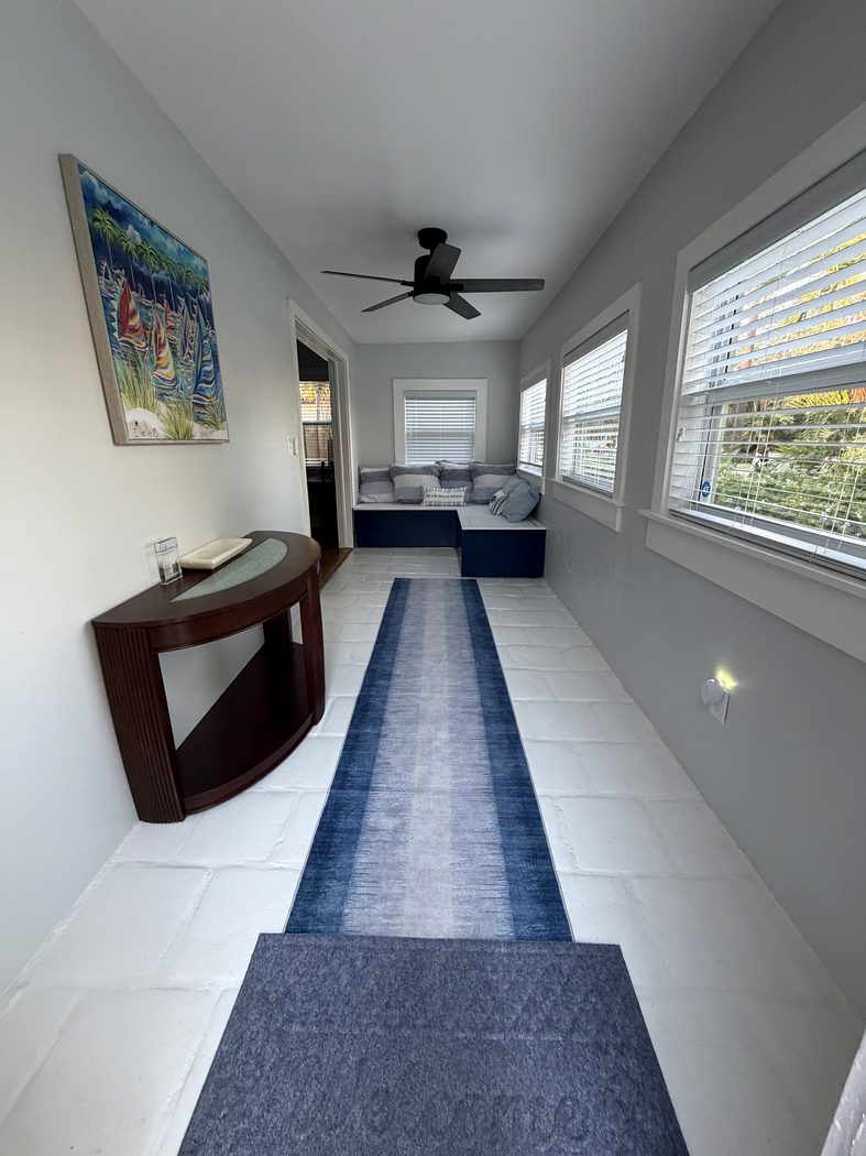 Entryway with sunroom seating beyond