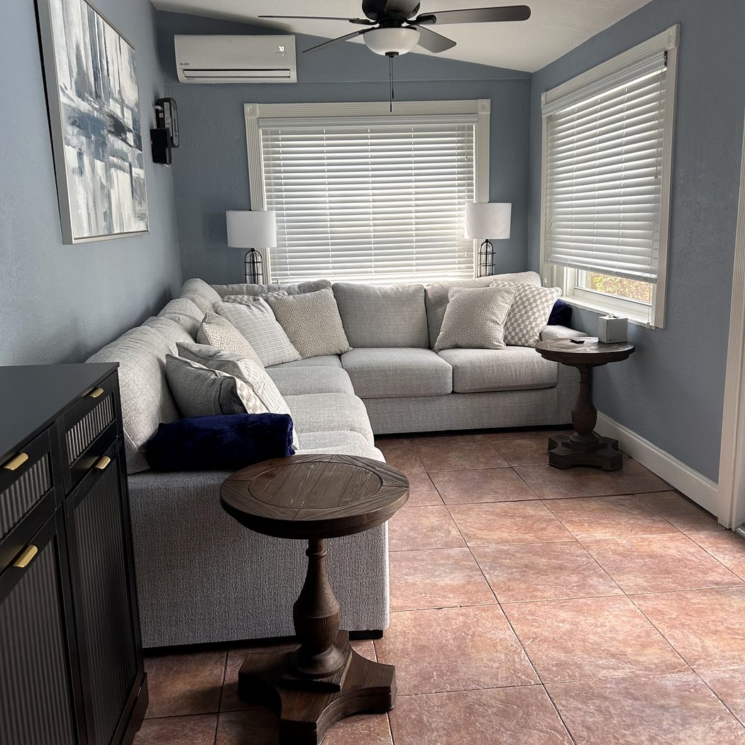 Back room with sectional sofa and mini split AC