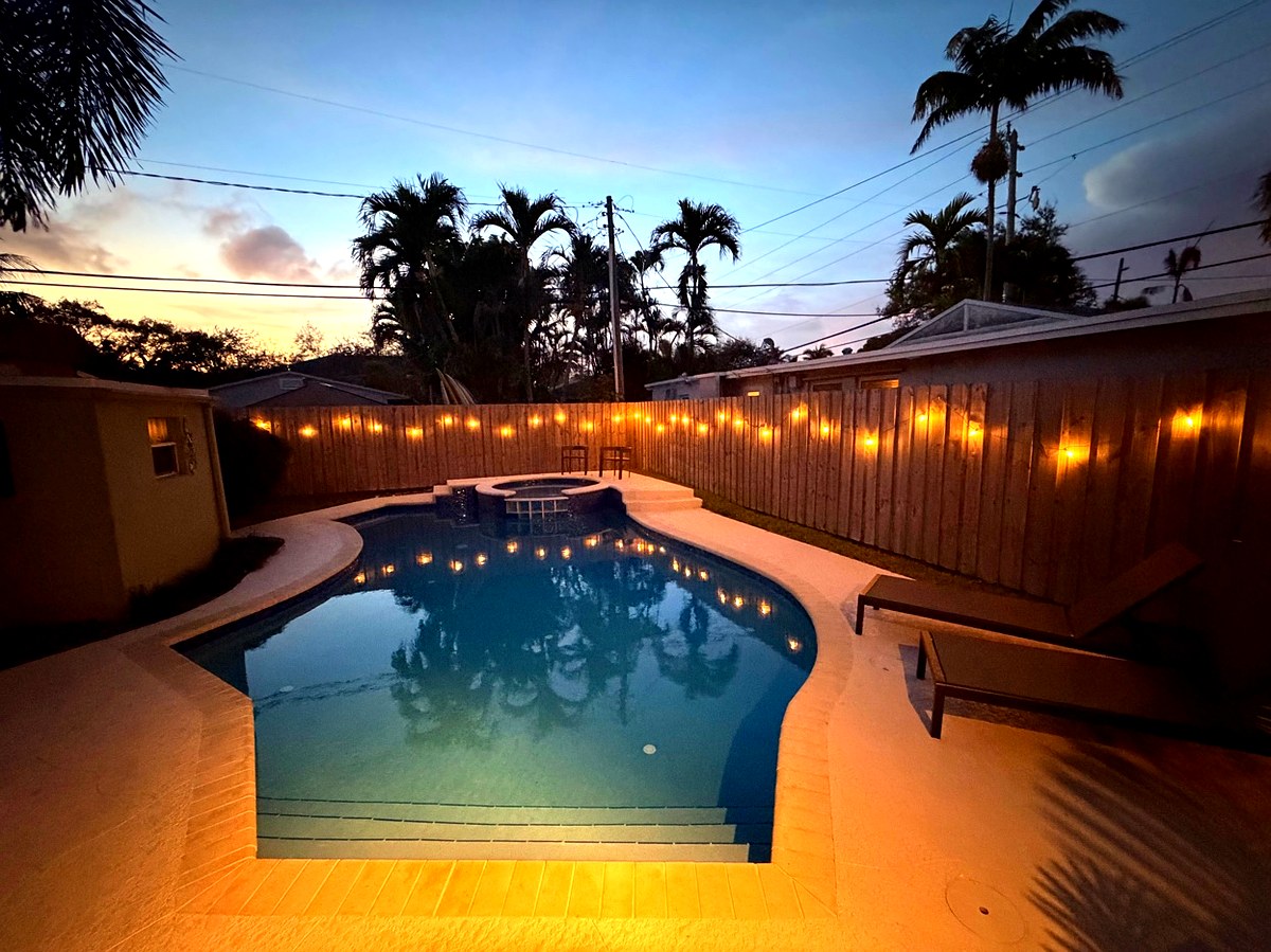 Heated pool illuminated at night with string lights