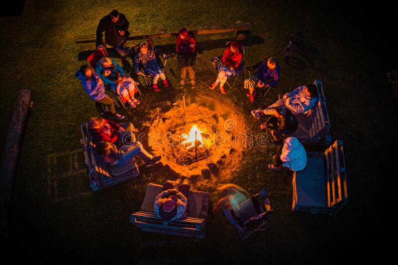 image of people singing around a bonfire