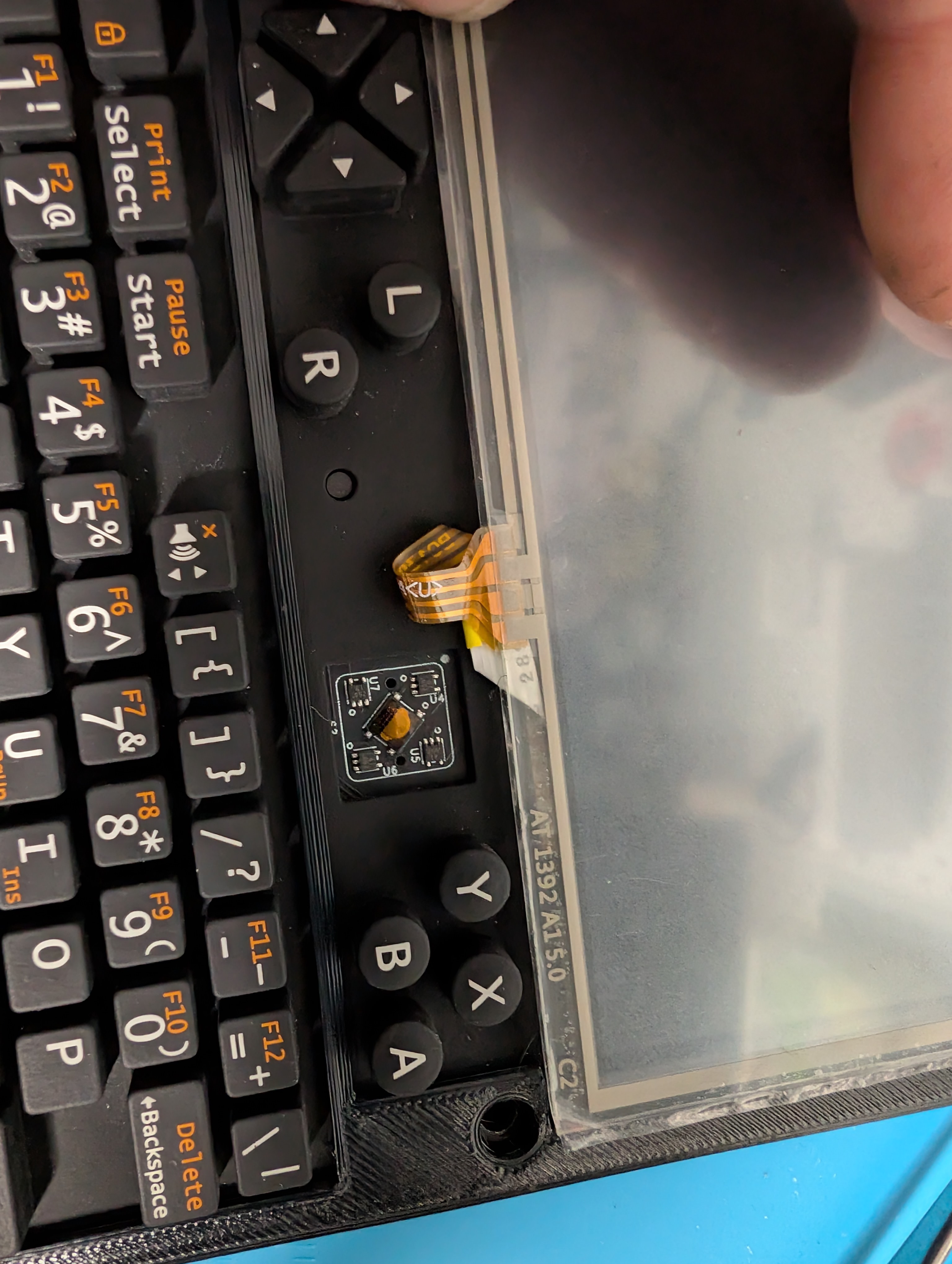 A resistive digitizer laid on top of the internal uConsole screen, its four wires disappearing into the chassis.