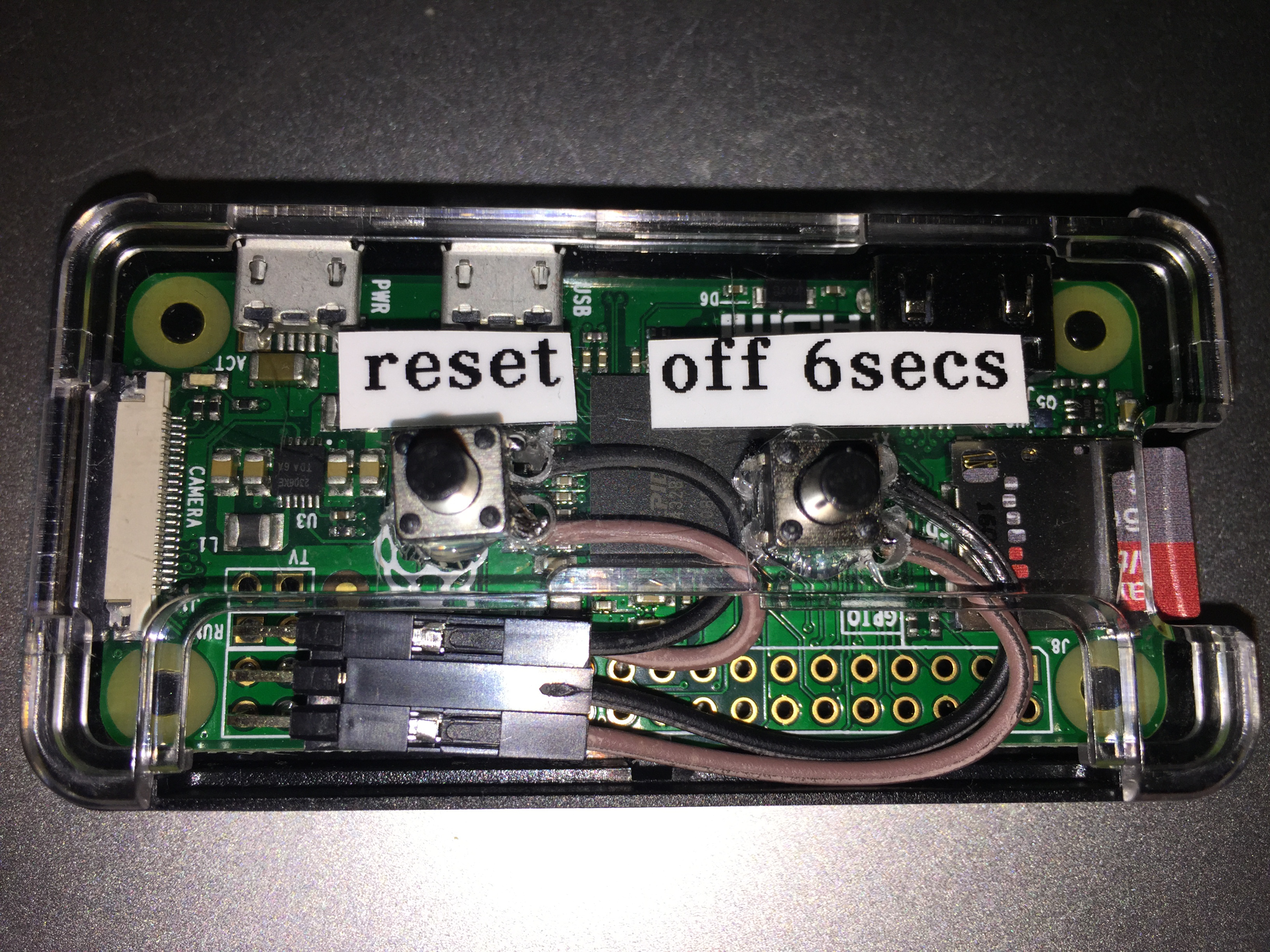 Example of Both an Off and Reset Switch on a Raspberry Pi Zero. Right angle headers are used for a compact connection. The switches are mounted directly onto an Adafruit case.