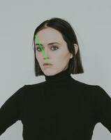 Woman with green line across face