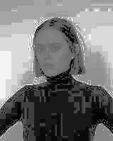 Highly pixelated and poor quality photo of woman in black turtleneck on white background in grayscale