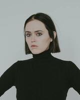 Woman with black turtleneck and white background