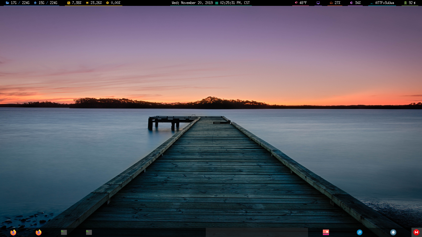 A picture of the desktop on the third workspace with the desktop wallpaper, of a sunset, visible and the two top/bottom panels