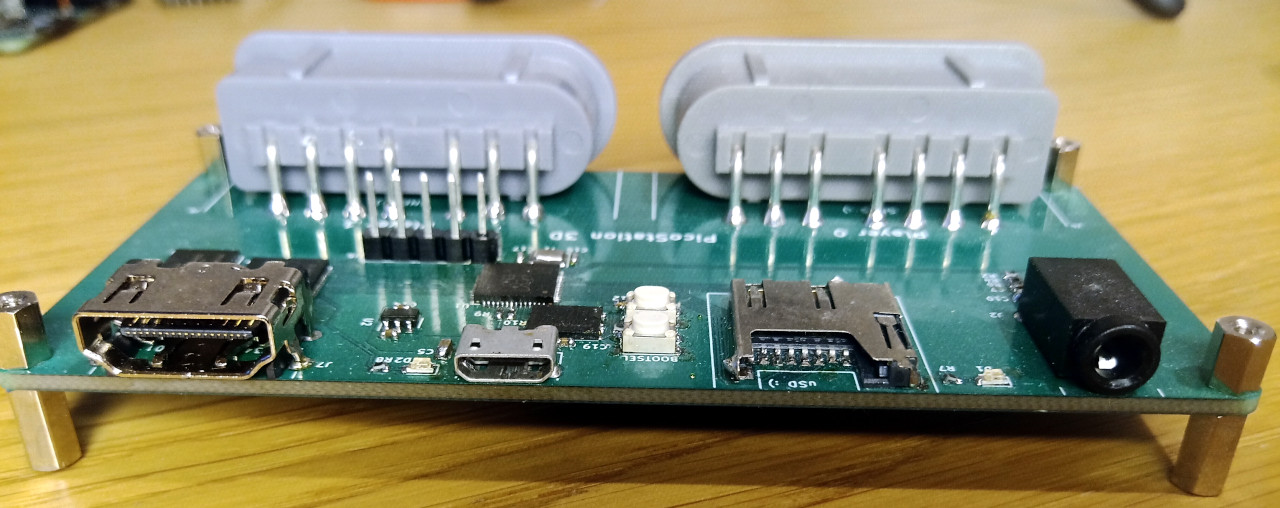 Rear view of a prototype board, showing left to right the HDMI socket, FPGA LED, USB socket, SD card slot, microcontroller LED, and audio jack.