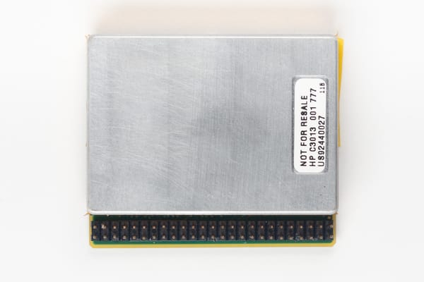 HP Kittyhawk hard drive, top: brushed metal lid with a 'NOT FOR RESALE HP C3013' label, pin header along the lower edge
