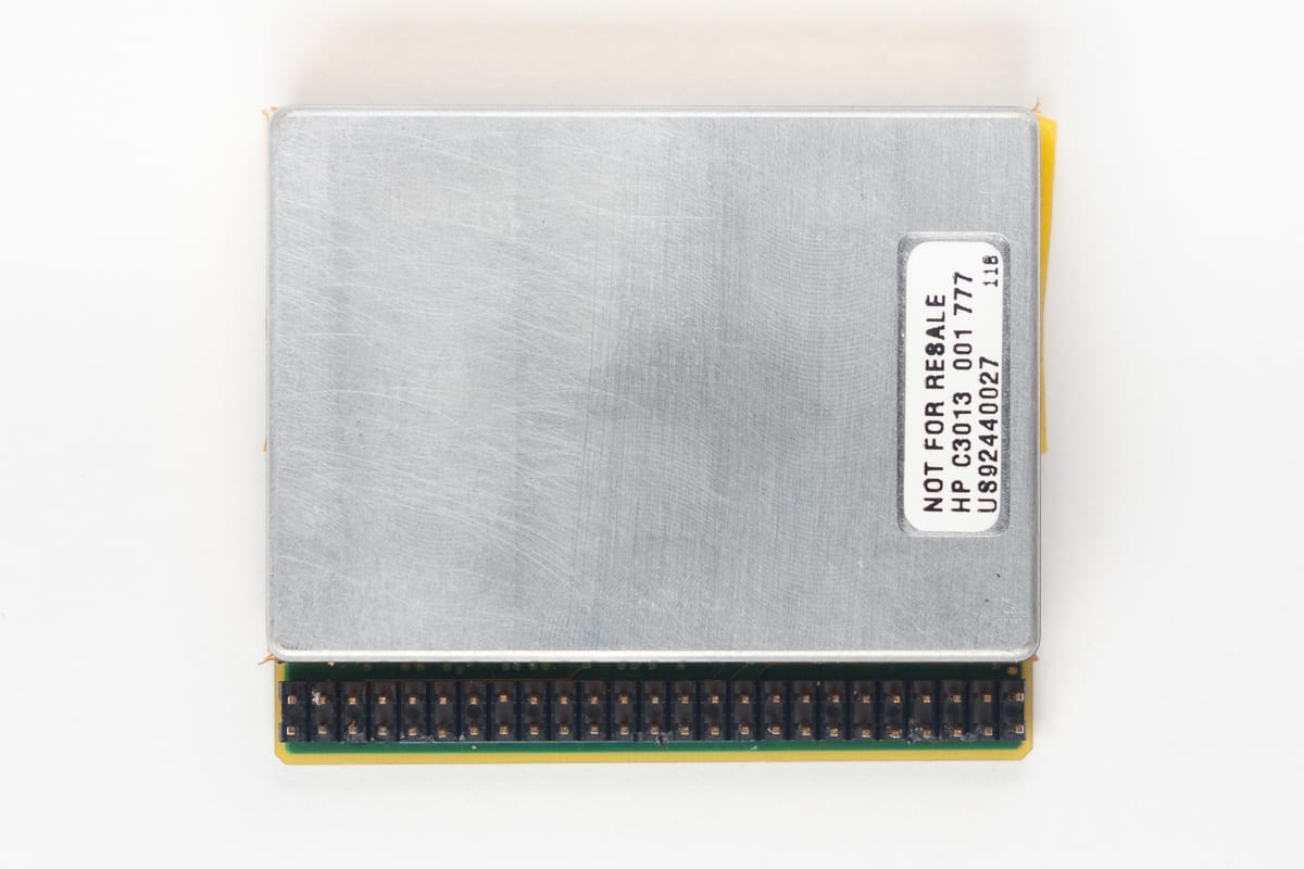 HP Kittyhawk hard drive, top: brushed metal lid with a 'NOT FOR RESALE HP C3013' label, pin header along the lower edge