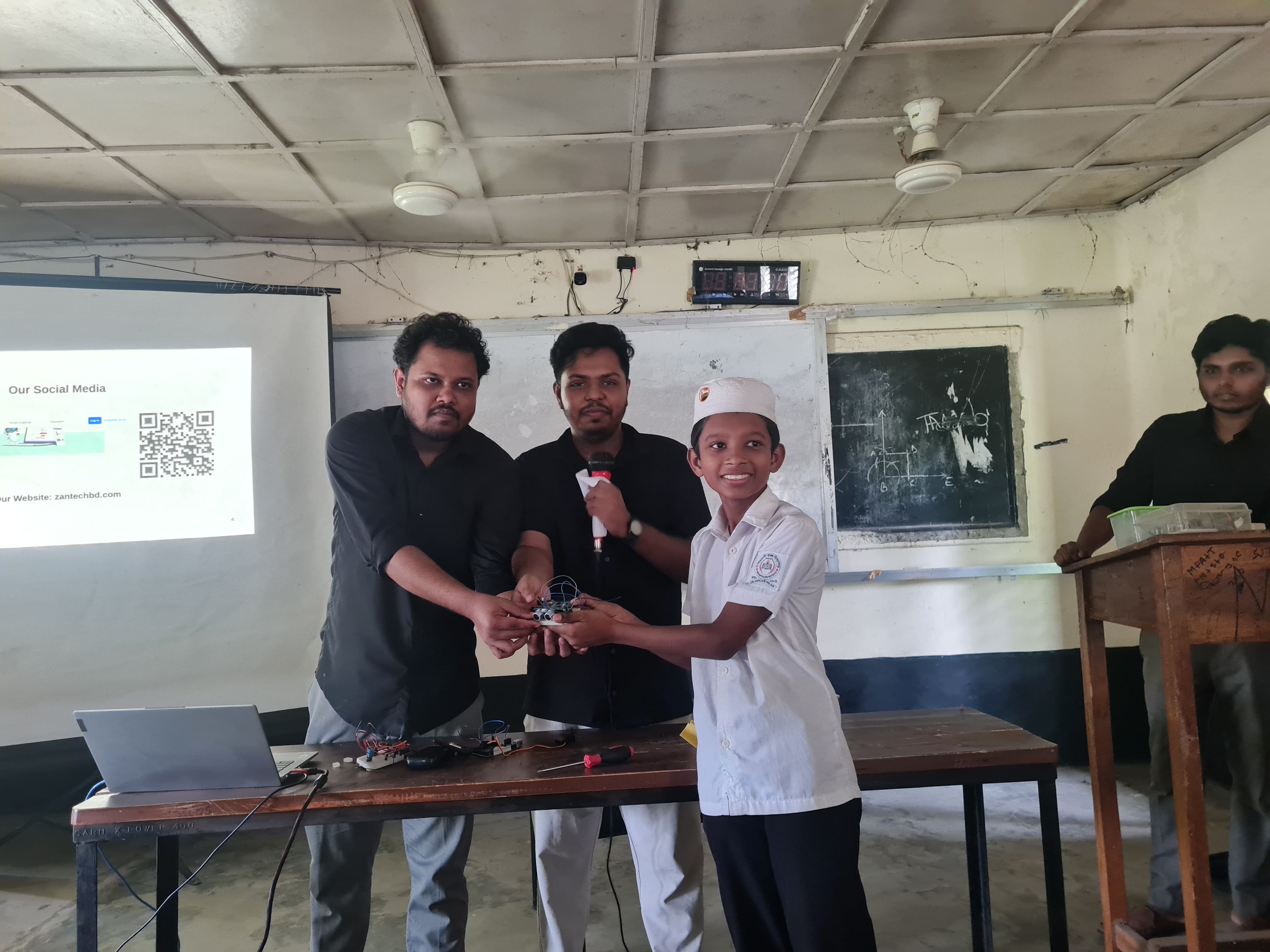 Students building robots at Sharishadi High School, Feni