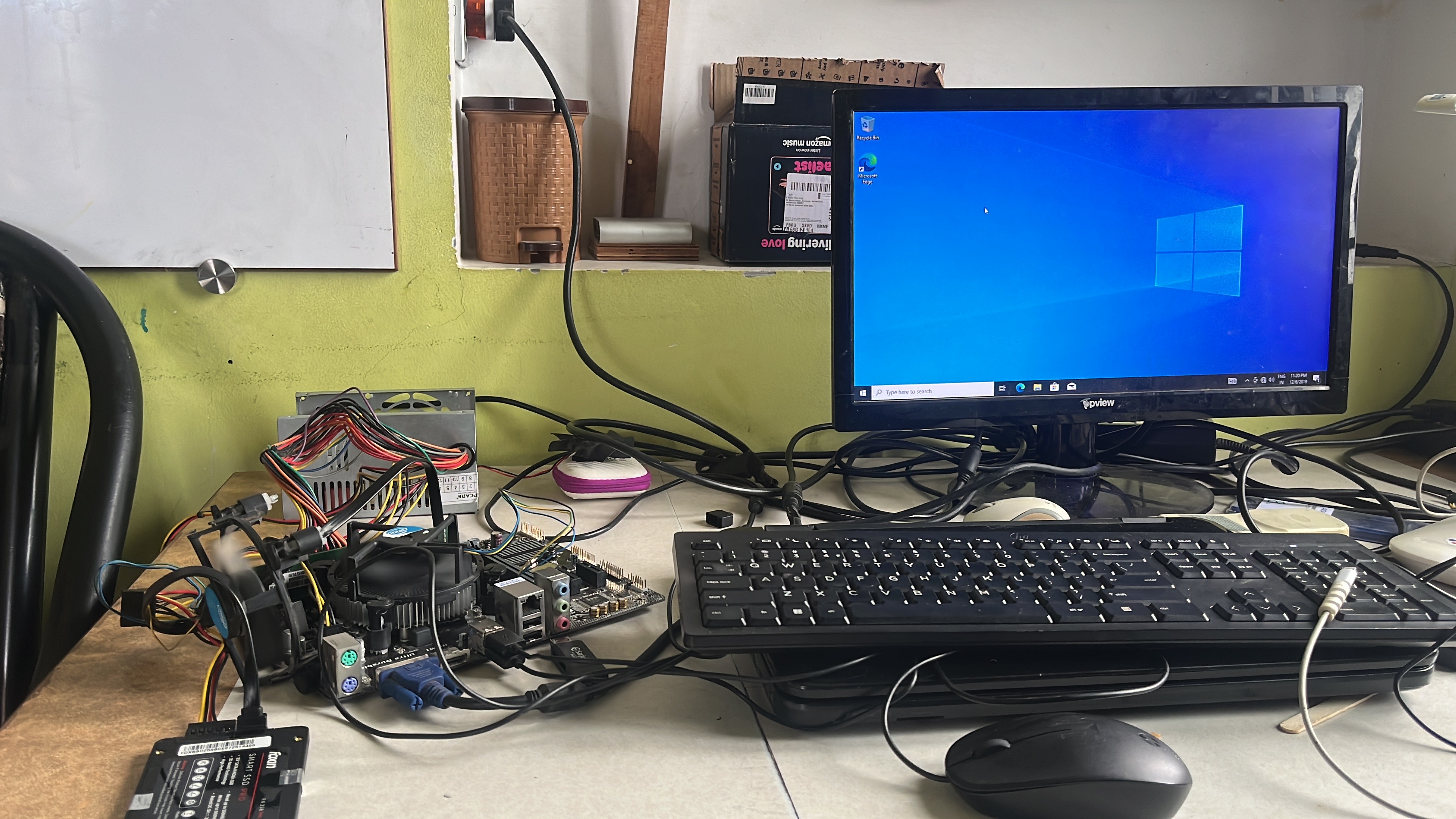 A salvaged PC running open on a bench