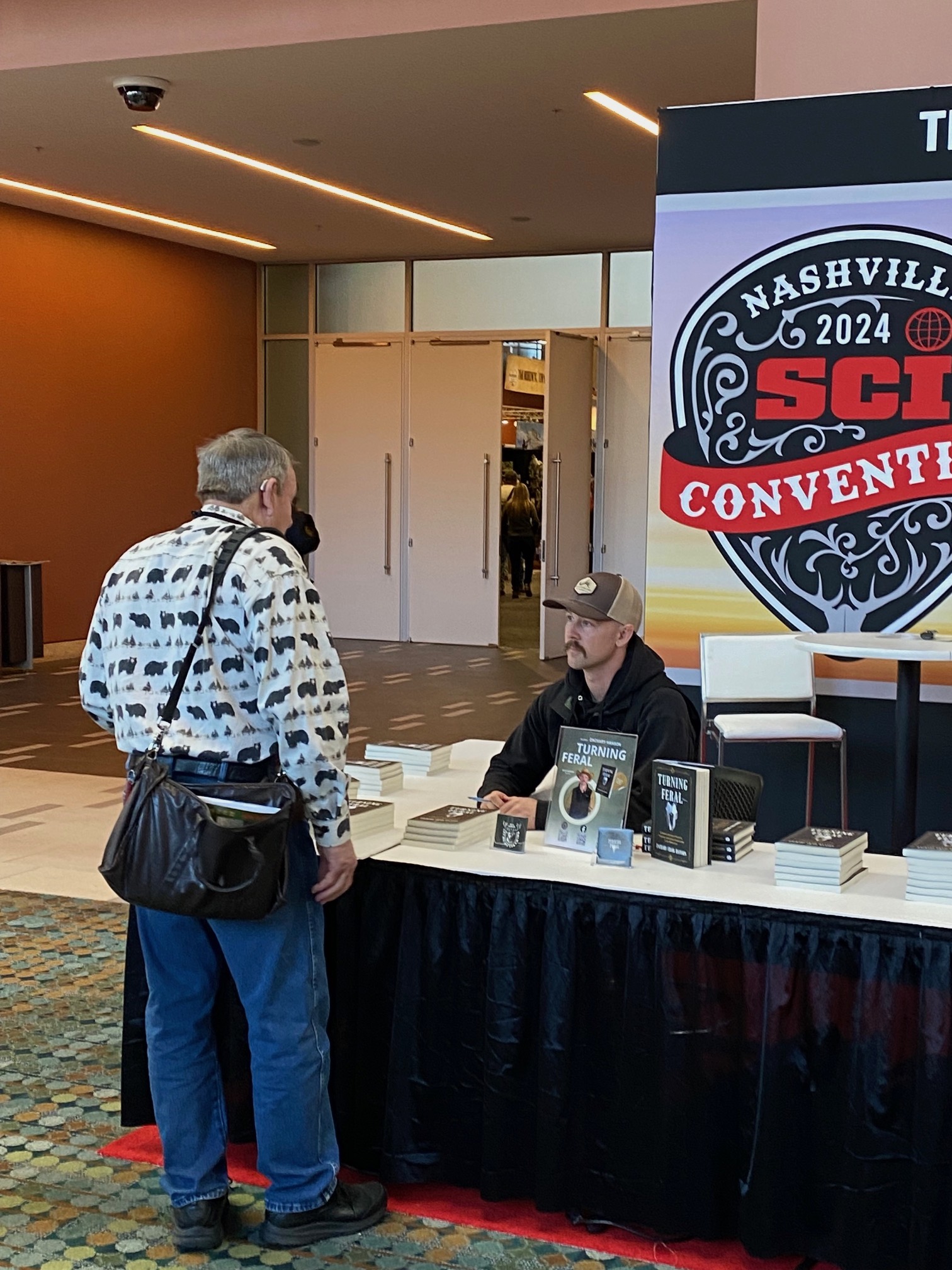 Zach signing copies of Turning Feral at the SCI Convention in Nashville
