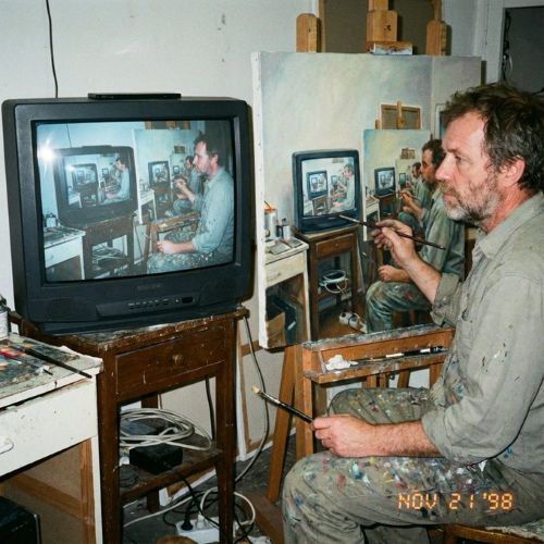 Amateur photograph from 1998 of a middle-aged artist copying an image by hand from a computer screen to an oil painti…