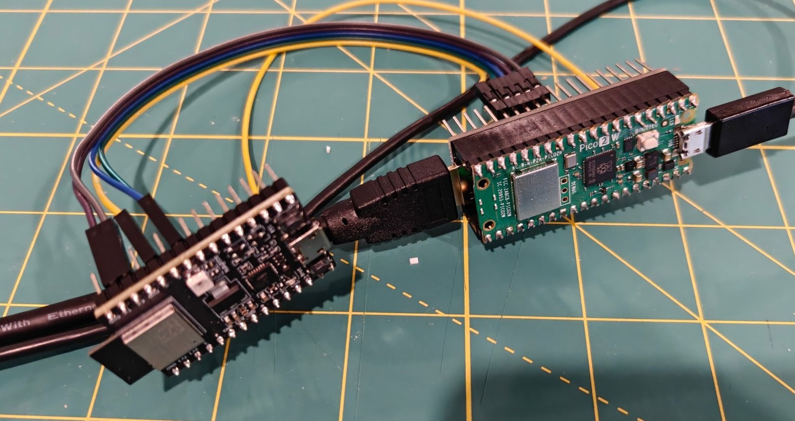 A Pico 2 W wired to an ESP32-C3 DevKitM-1, with an HDMI cable between them
