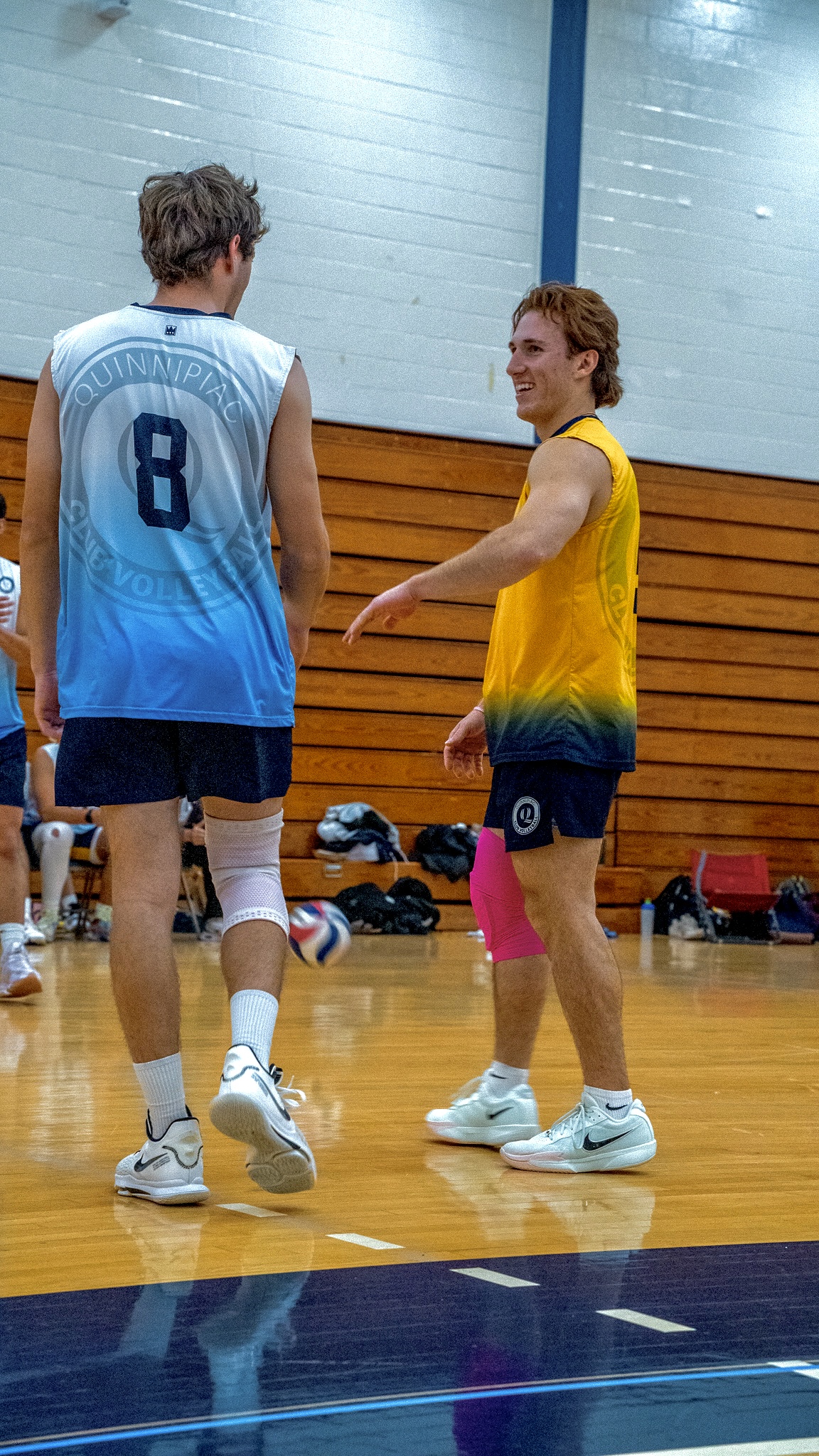 Adam Witkowski talking with a teammate on court