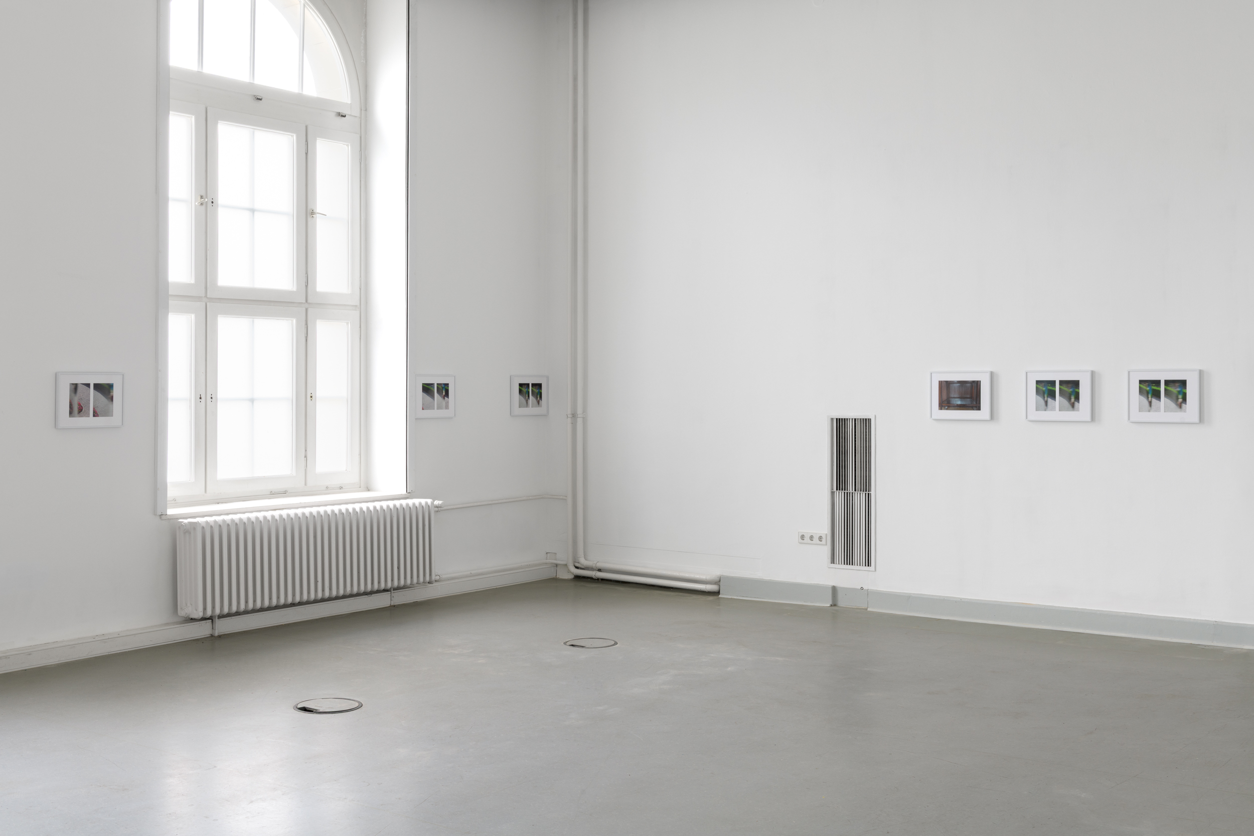 Aisha Altenhofen, The Carrier at UdK Berlin: Wide installation view showing the grey gallery floor, high ceilings, and the complete series of six photographic works.