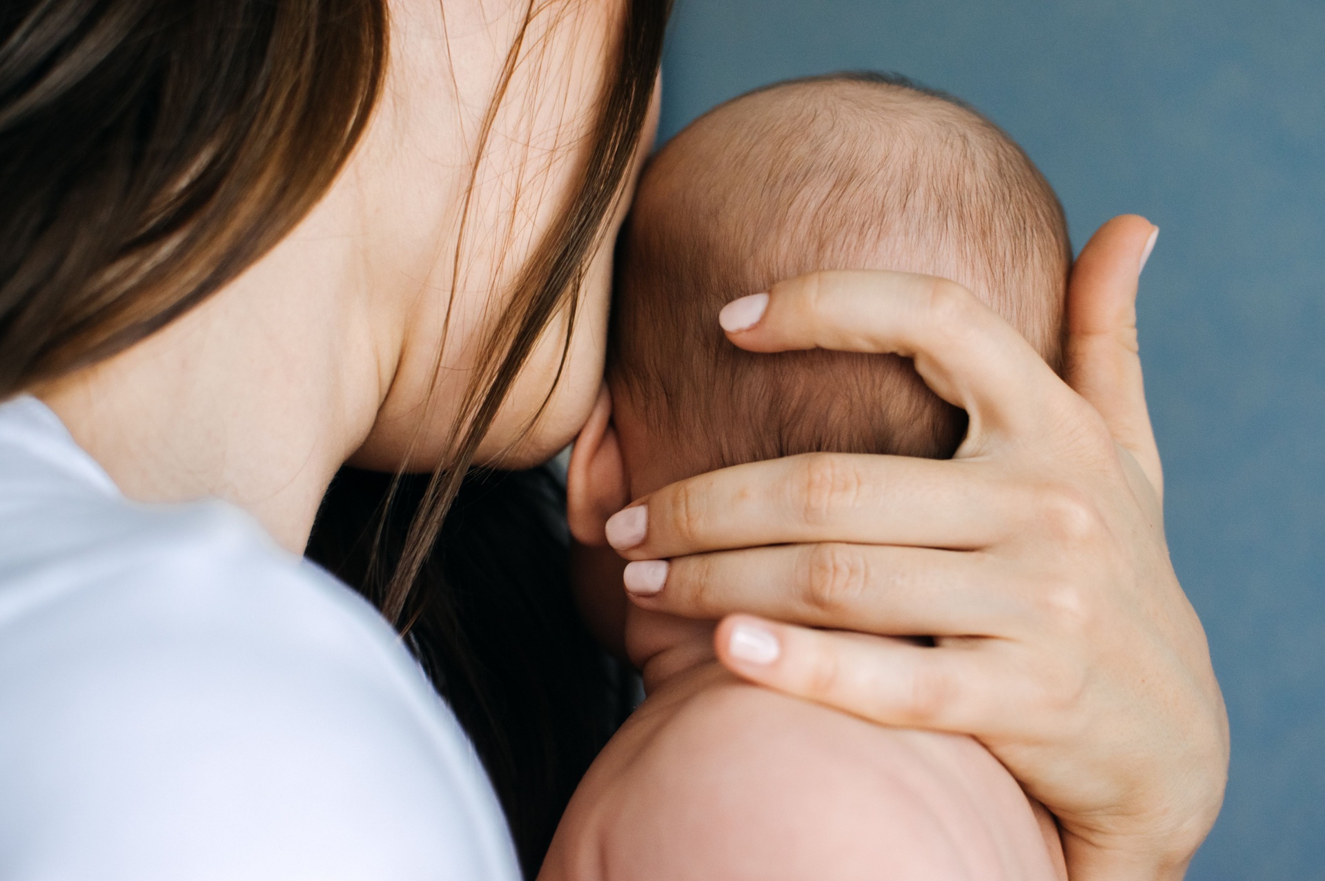Mother holding newborn baby close