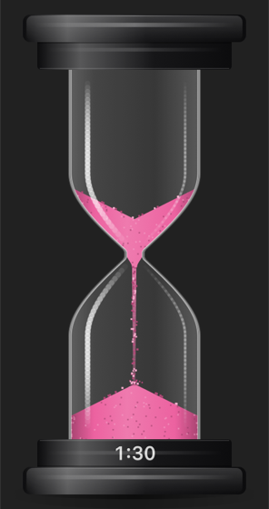 The timer with rose sand on a dark desktop
