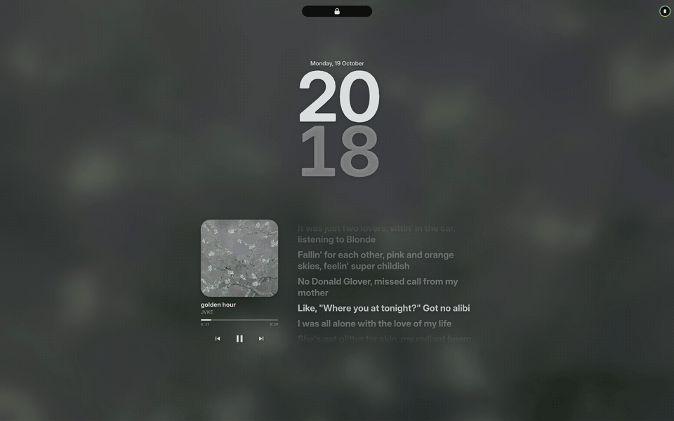 The lock screen over the blurred cover of the track playing, the lyrics moving line by line beside the cover, then a touch: a ring turns round the padlock, closes green, and the blur lifts off the desk