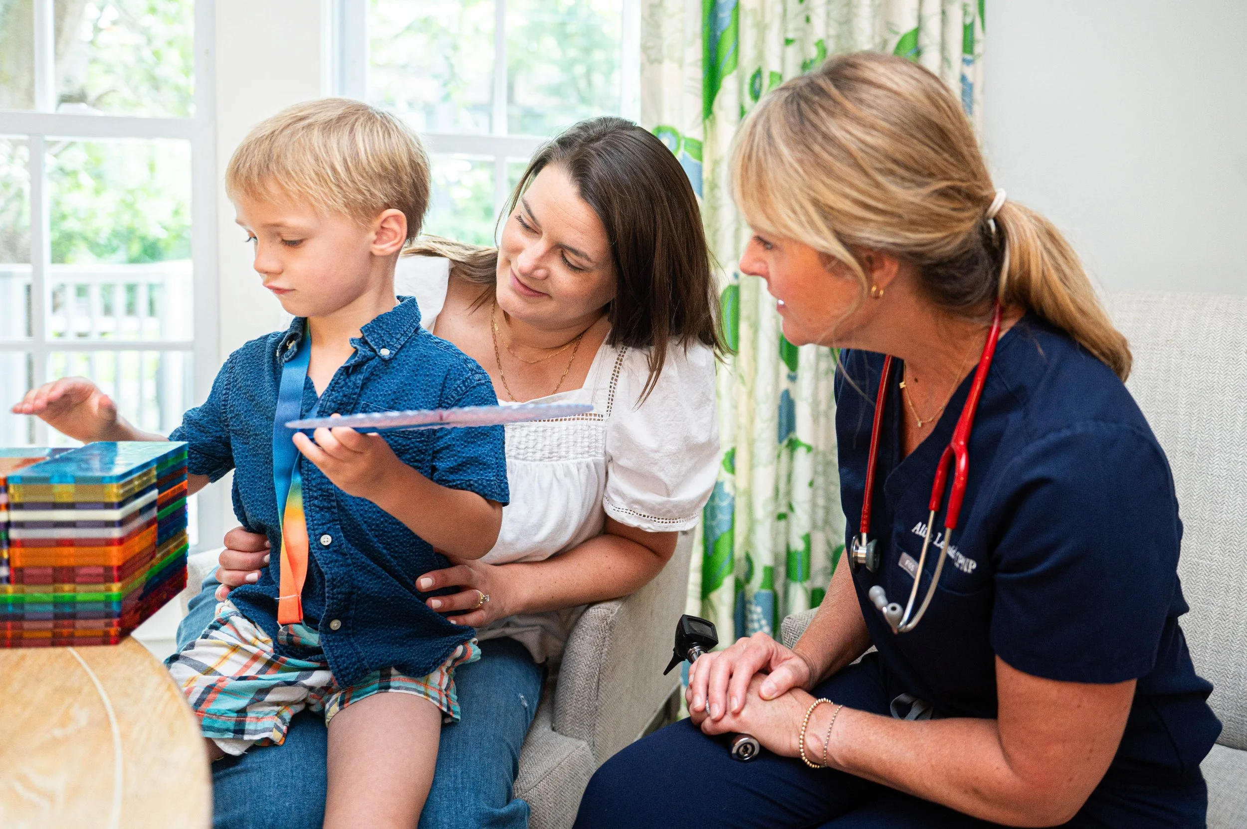 Alice with a mother and her son in a living room