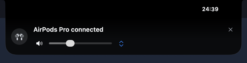 'AirPods Pro connected' in the notch, with a volume slider and an output switch.