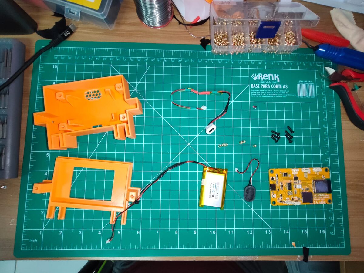 All the parts before assembly: printed case, board, battery, speaker, USB-C breakout