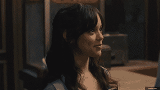 A character smiling during a conversation in a cozy setting.