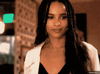 Zoe Kravitz Smiles Softly While Engaging in a Conversation