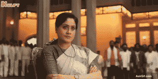 Vijayashanti Stares Intently With Arms Crossed in a Serious Moment