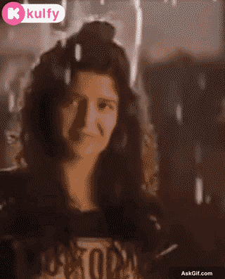 Ritika Singh Smiles Warmly Under the Rain, Radiating Joy